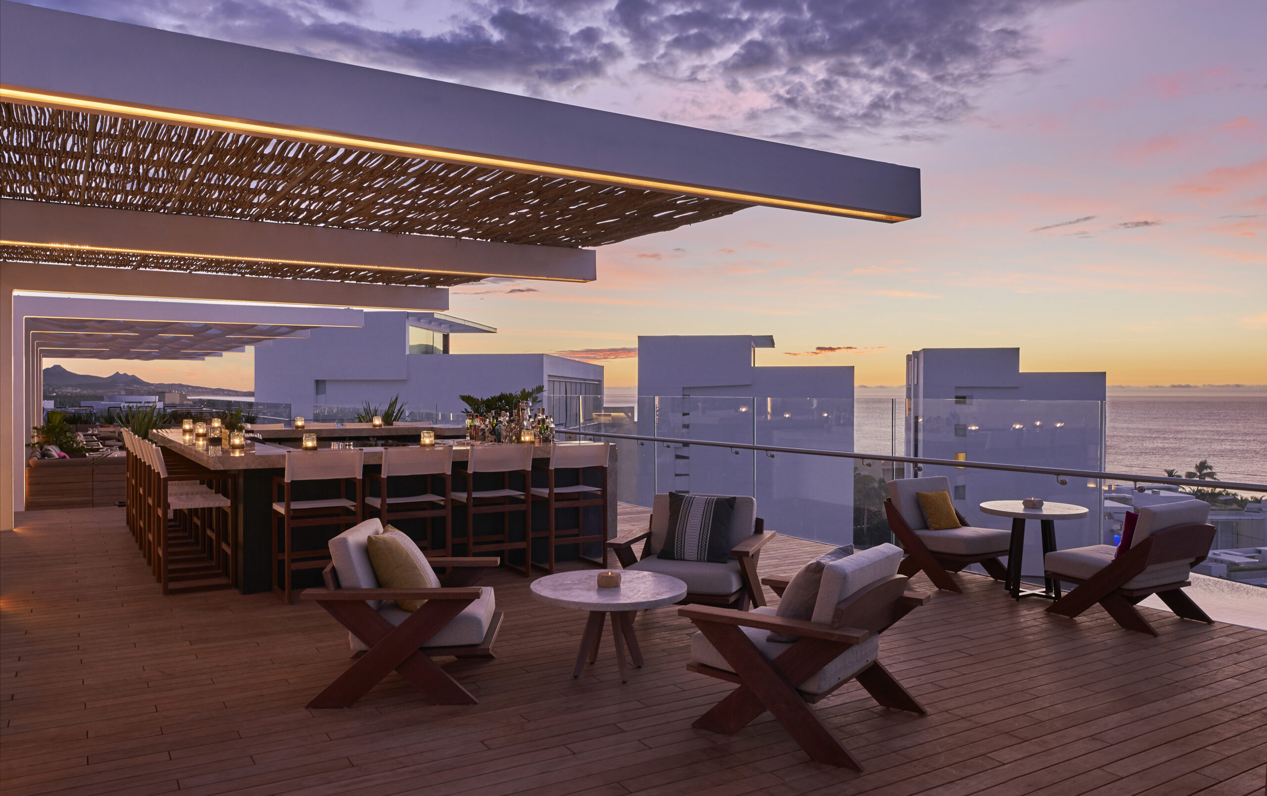 Viceroy Los Cabos rooftop bar at sunset. Mexico wedding beach resort with lounge seating and ocean view.