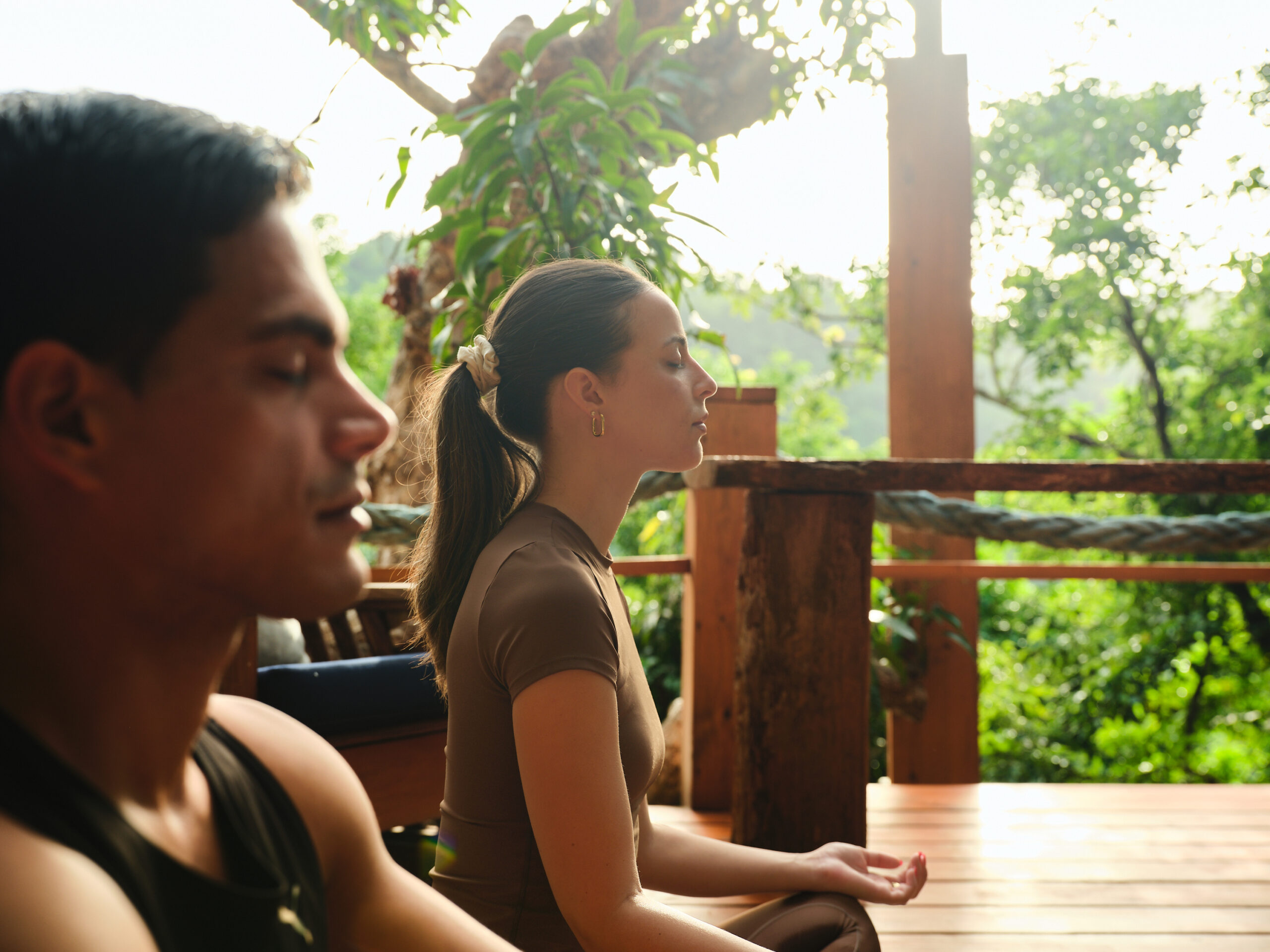 Couple meditating outdoors at Ladera Resort, ideal for an island wedding and honeymoon.