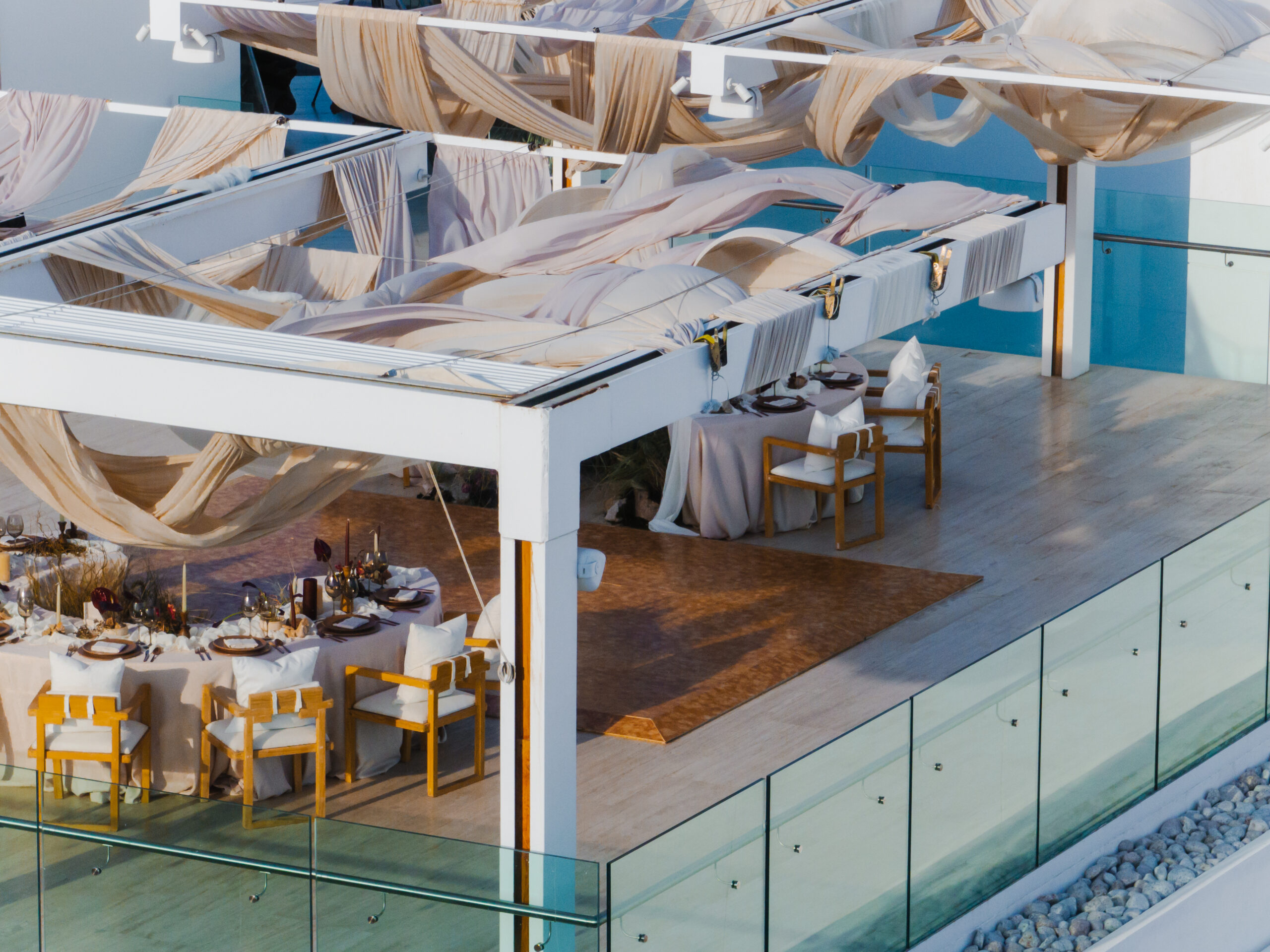 Viceroy Los Cabos wedding reception setup with draped pergola and ocean view.