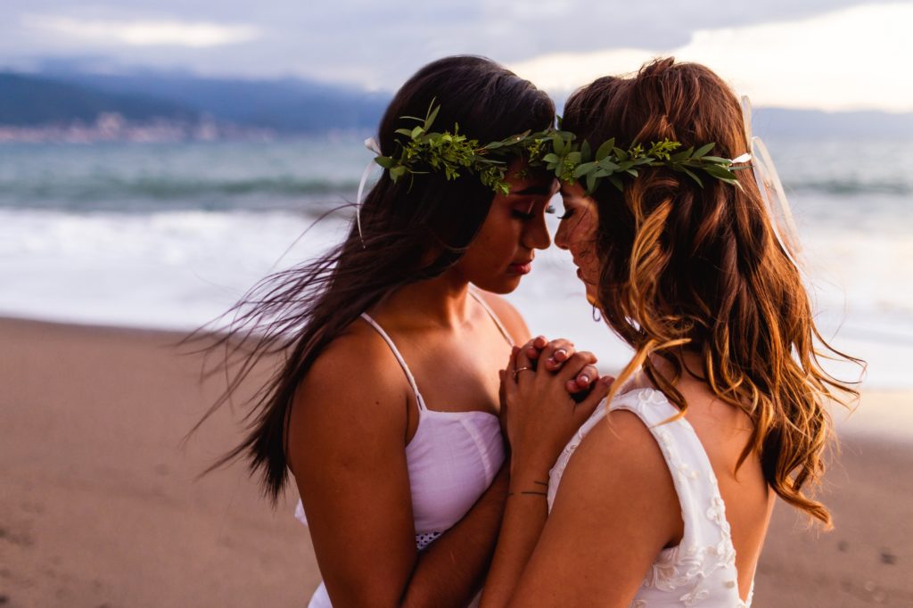 Women getting married on the beach