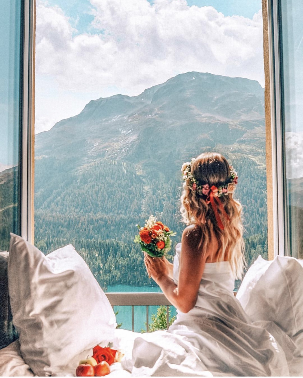 Bride looking at Swiss mountain range