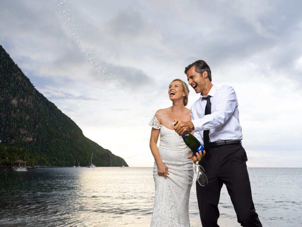 Wedding couple popping champagne