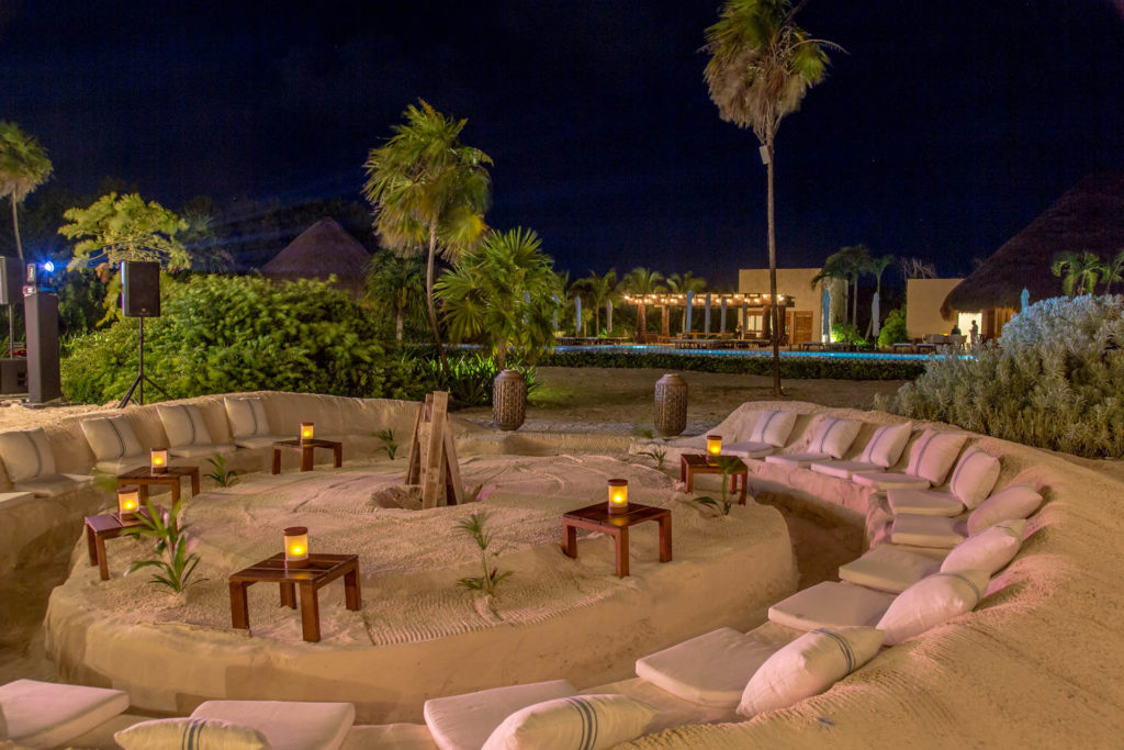 Outdoor circular seating on the sand at night