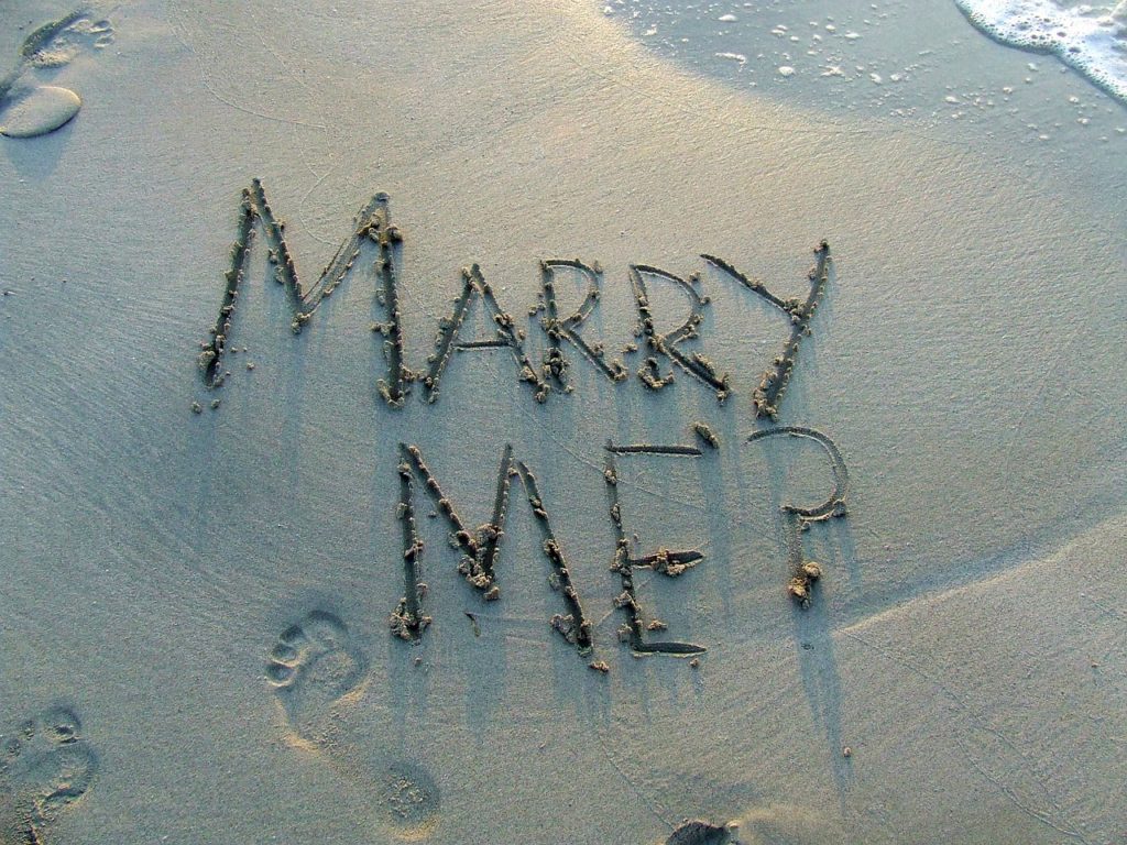 Marry Me drawn in the sand