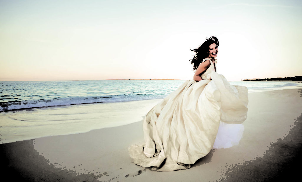 Bride running on the beach