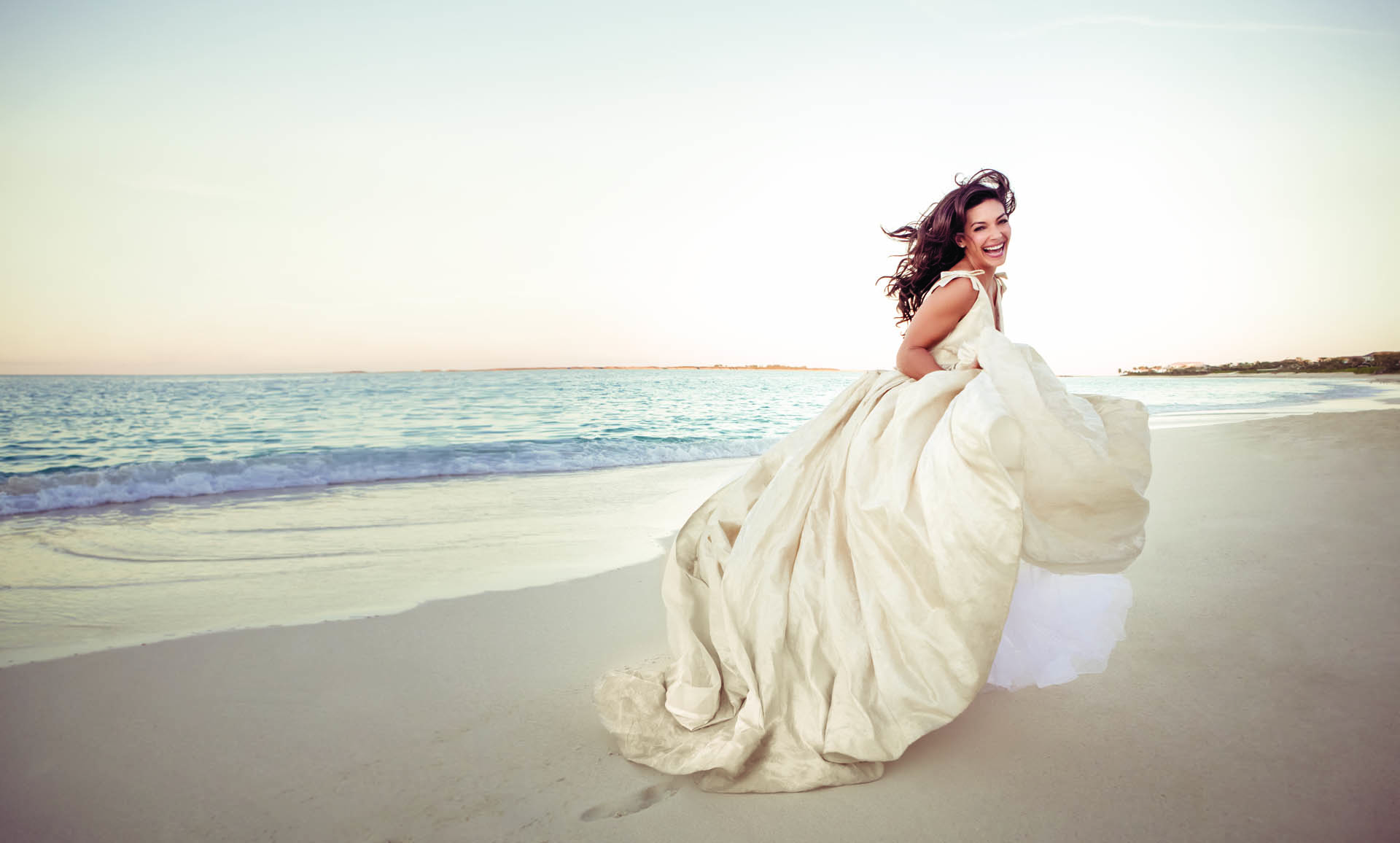 Bride running on the beach