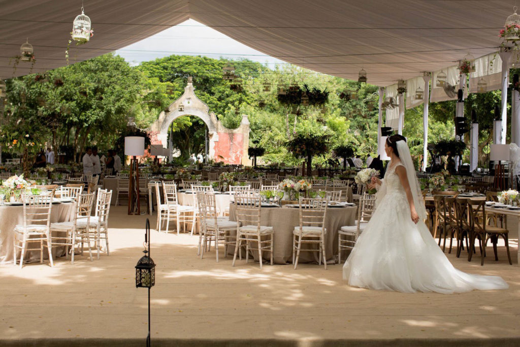 Bride walking through reception set up outdoors