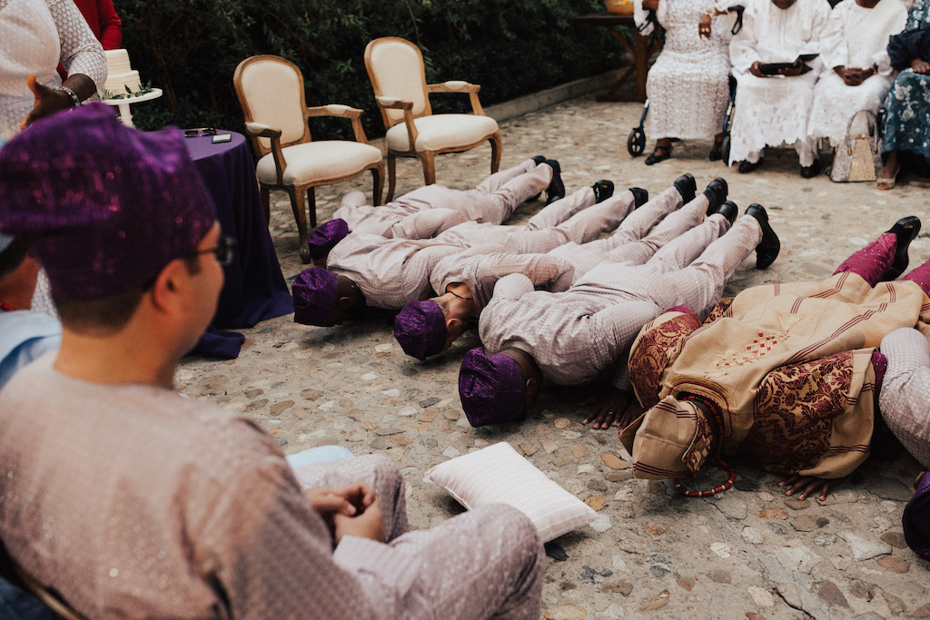 Nigerian wedding men in the wedding party prostrating themselves