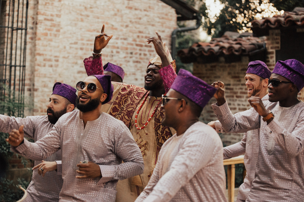 Nigerian wedding male guests dancing with groom