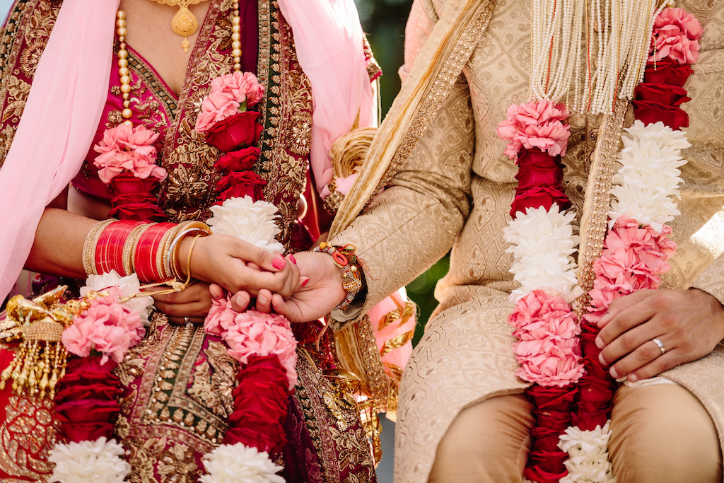 Indian wedding couple holding hands