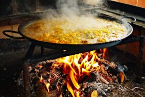 boiling paella over an open flame