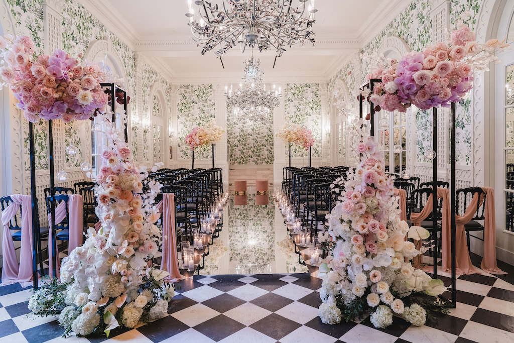 hotel wedding isle in checkered floor with pink flowers