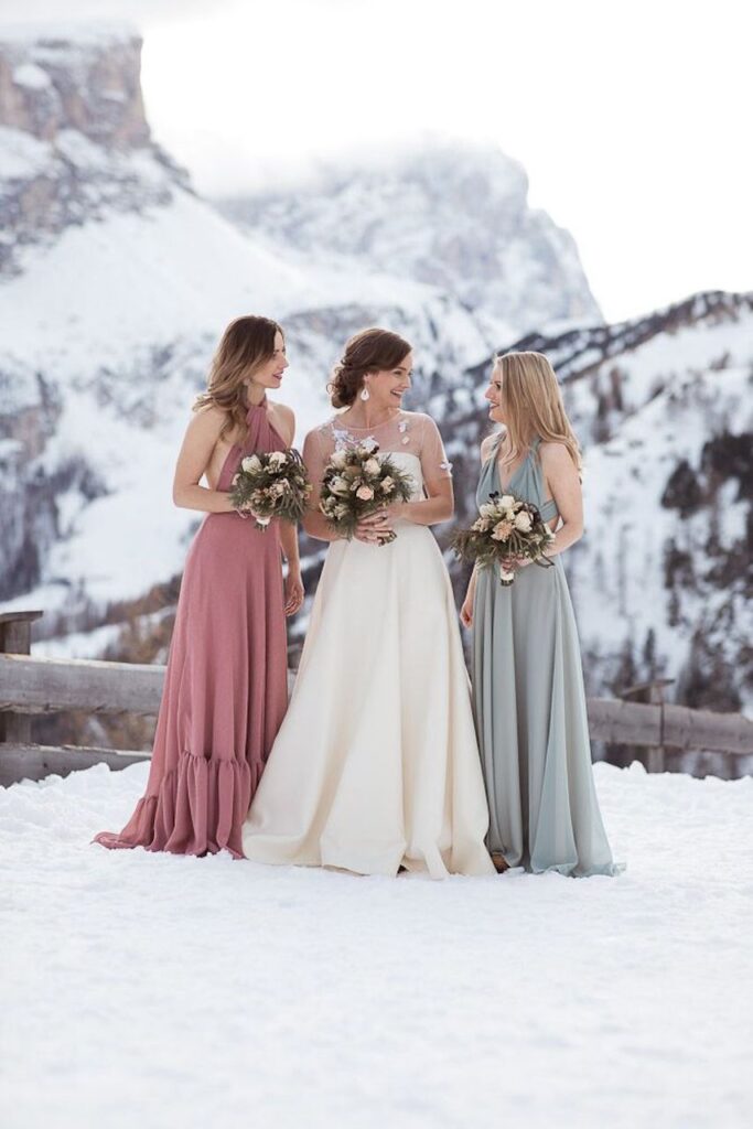 bride with 2 bridesmaids in the snowy mountains