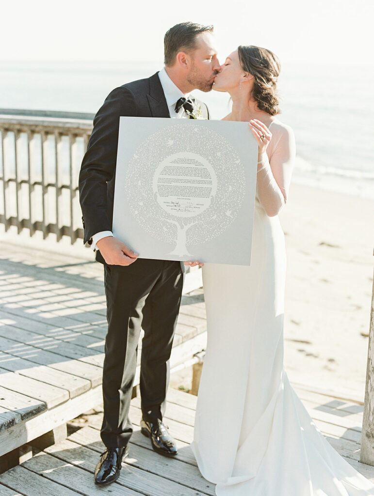 Wedding couple holding the contract or ketubah
