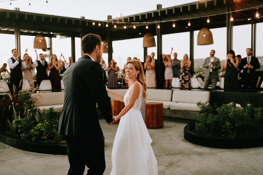 wedding couple surrounded by guests