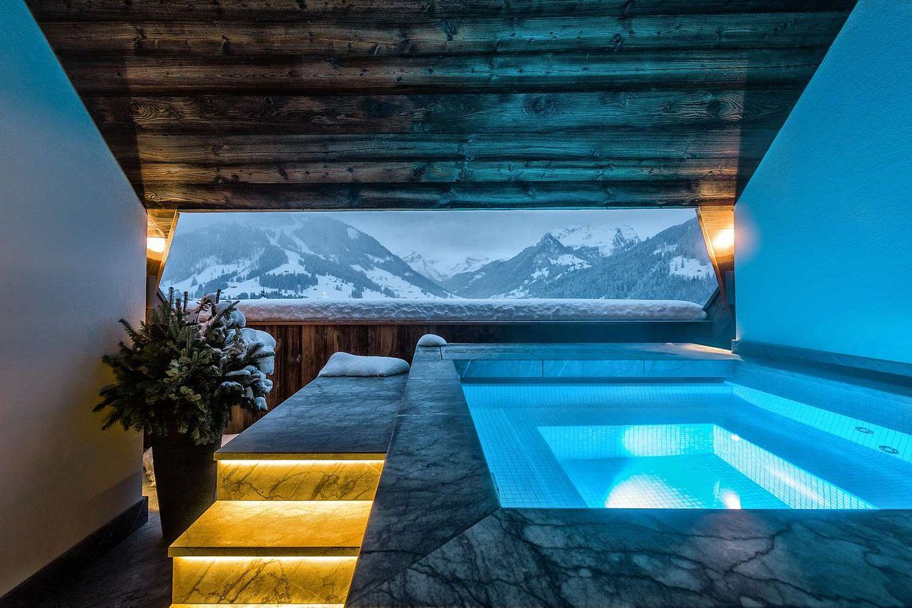 Spa pool with window overlooking the Swiss Alps in winter