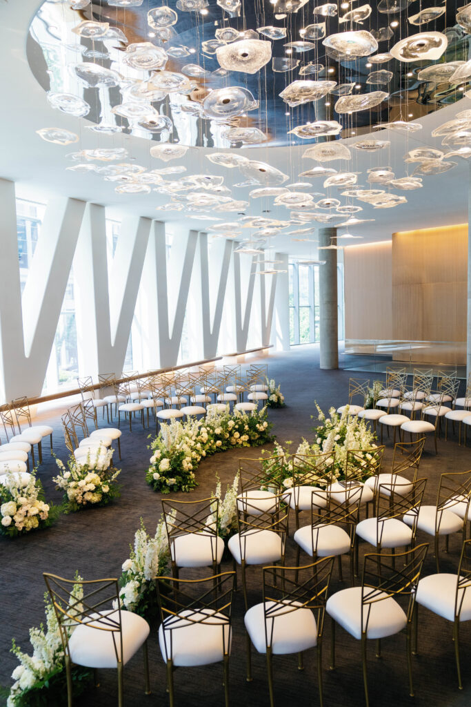 Conrad Washington, DC wedding ceremony setup with floral arrangements and modern decor.