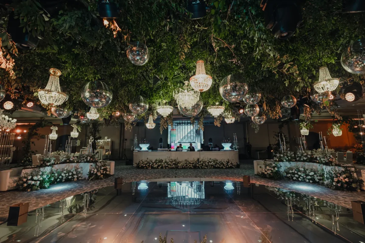 Elegant destination wedding reception at Kempinski Hotel Cancún with chandeliers and floral decor.