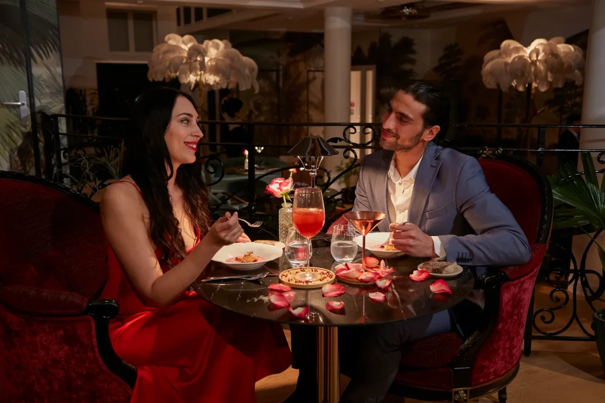 Romantic couple enjoying dinner at Paris hotel. Honeymoon destination.