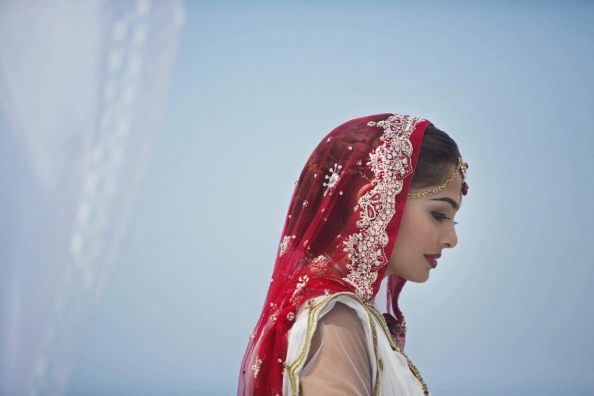 Bride in red veil during traditional Indian wedding ceremony