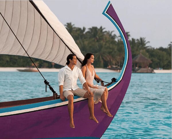 Couple enjoying a January honeymoon on a purple sailboat in tropical waters