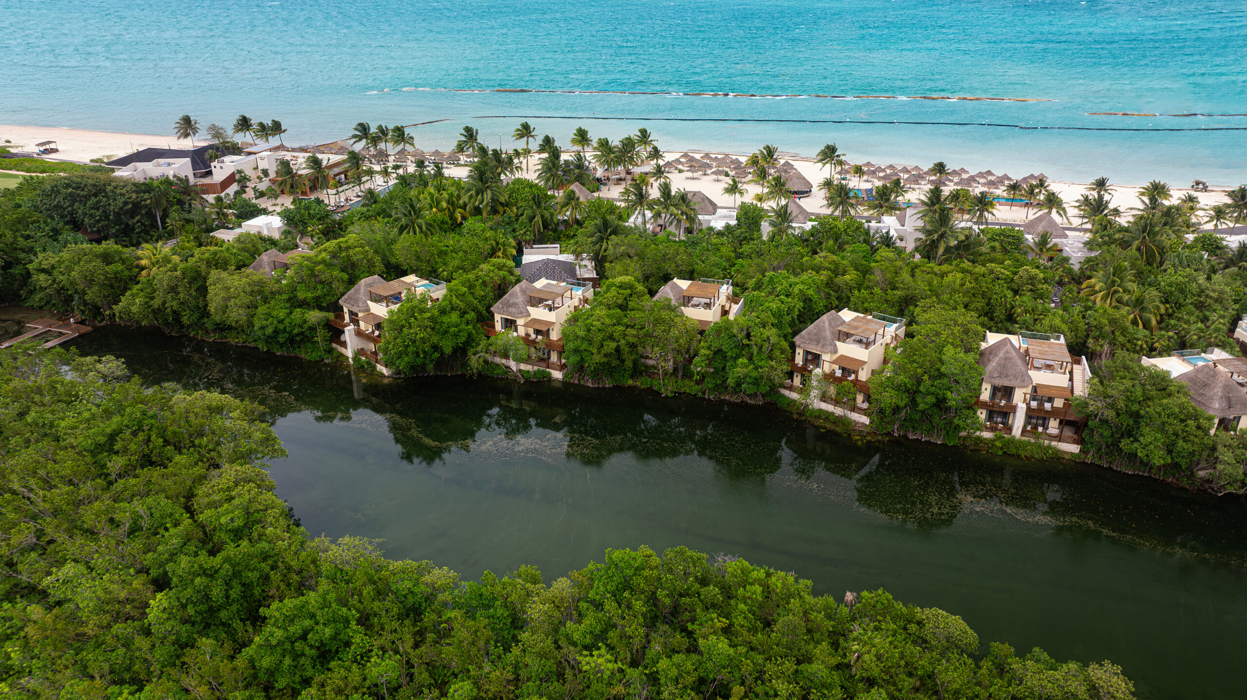 Fairmont Mayakoba aerial view of lagoon, beach, and wedding venue on Riviera Maya beach.