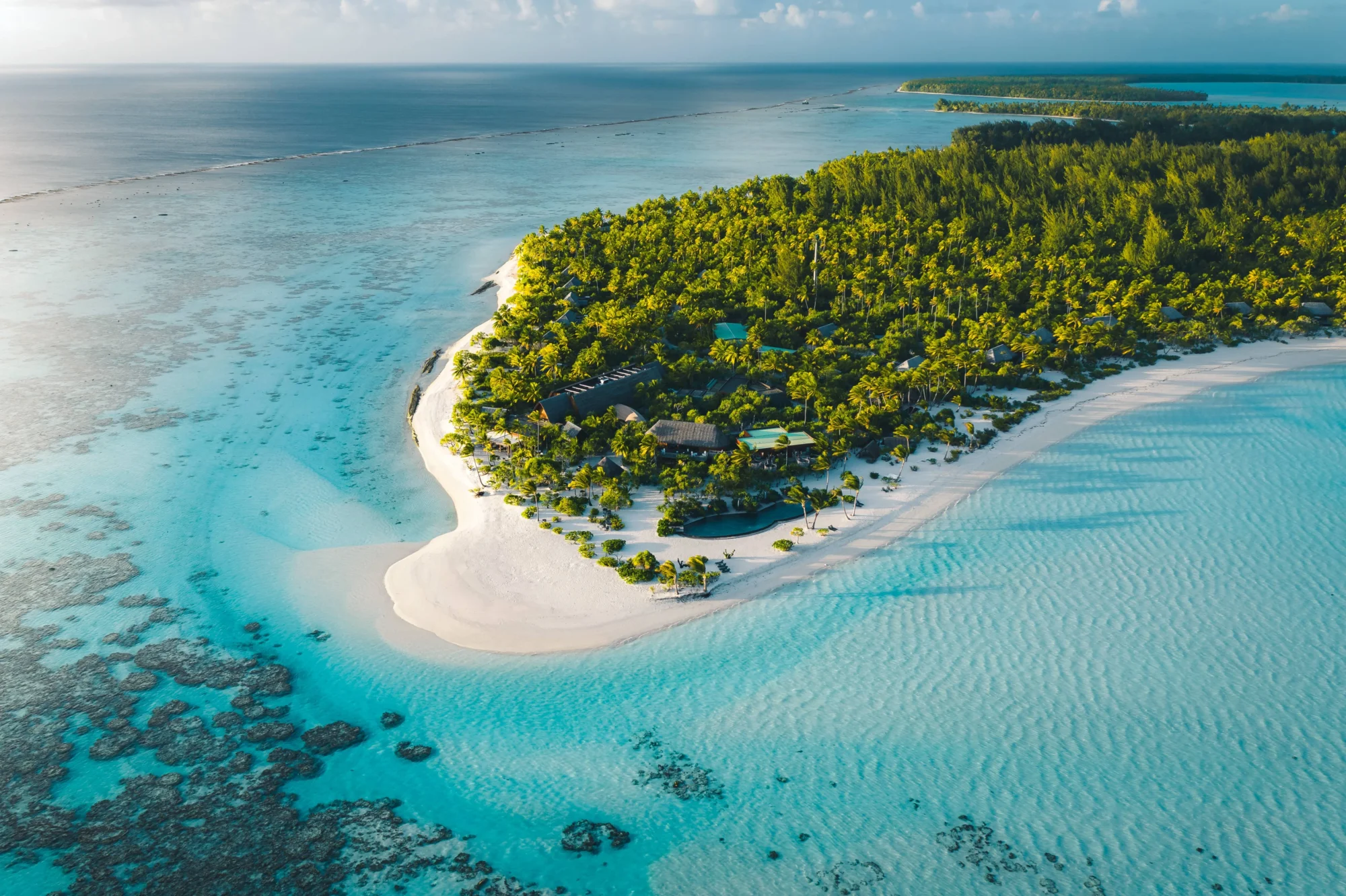 Aerial view of The Brando private island with turquoise water and white sand beach, perfect for a Tetiaroa wedding & honeymoon.