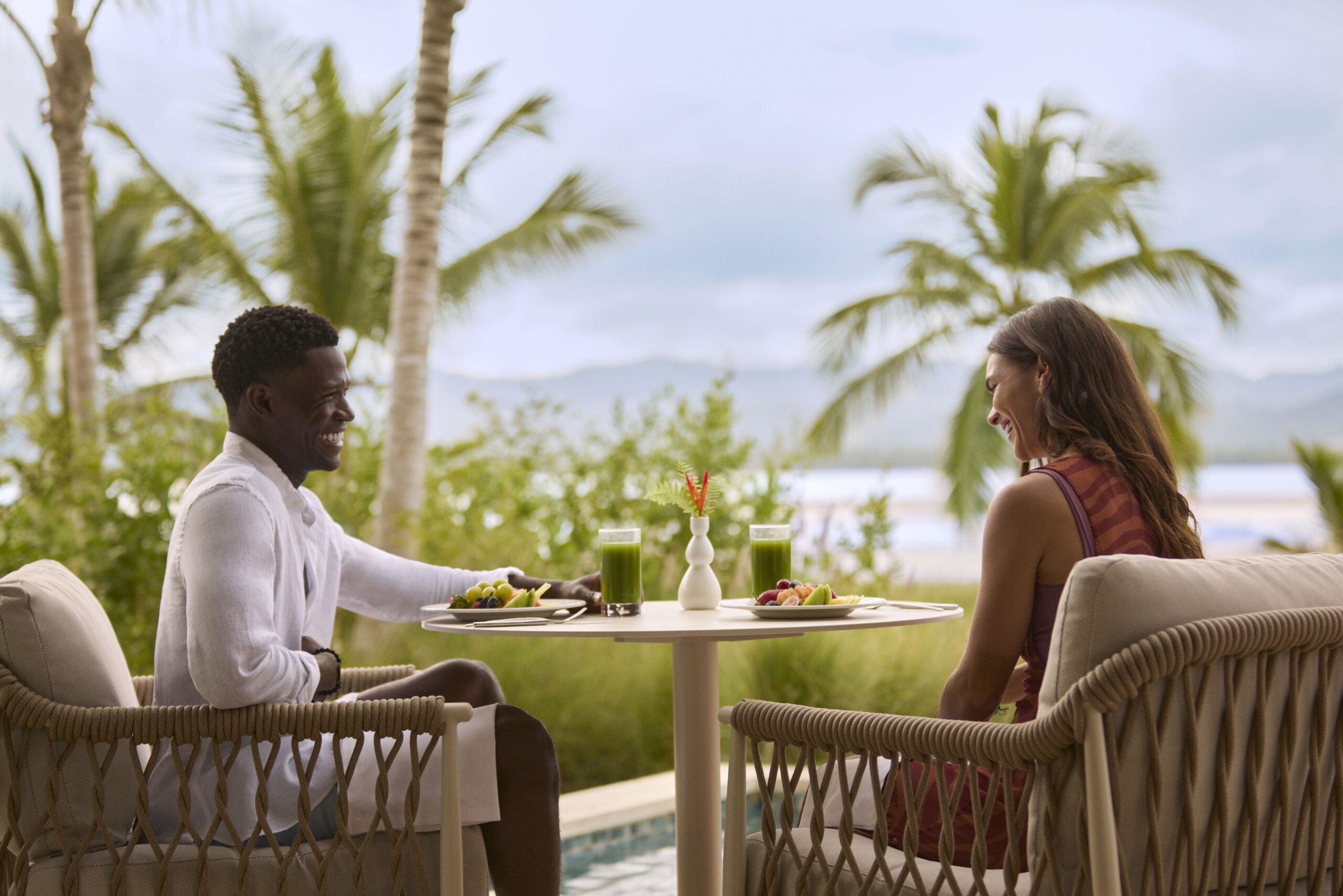 Couple dining at Zemi Miches All-Inclusive Resort, enjoying a meal with a tropical view.