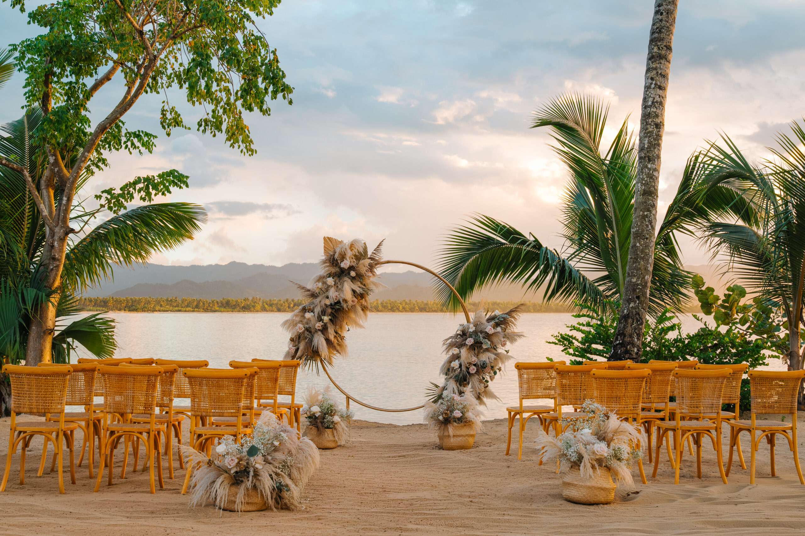 Sunset view of Zemi Miches All-Inclusive Resort beach wedding setup with yellow chairs