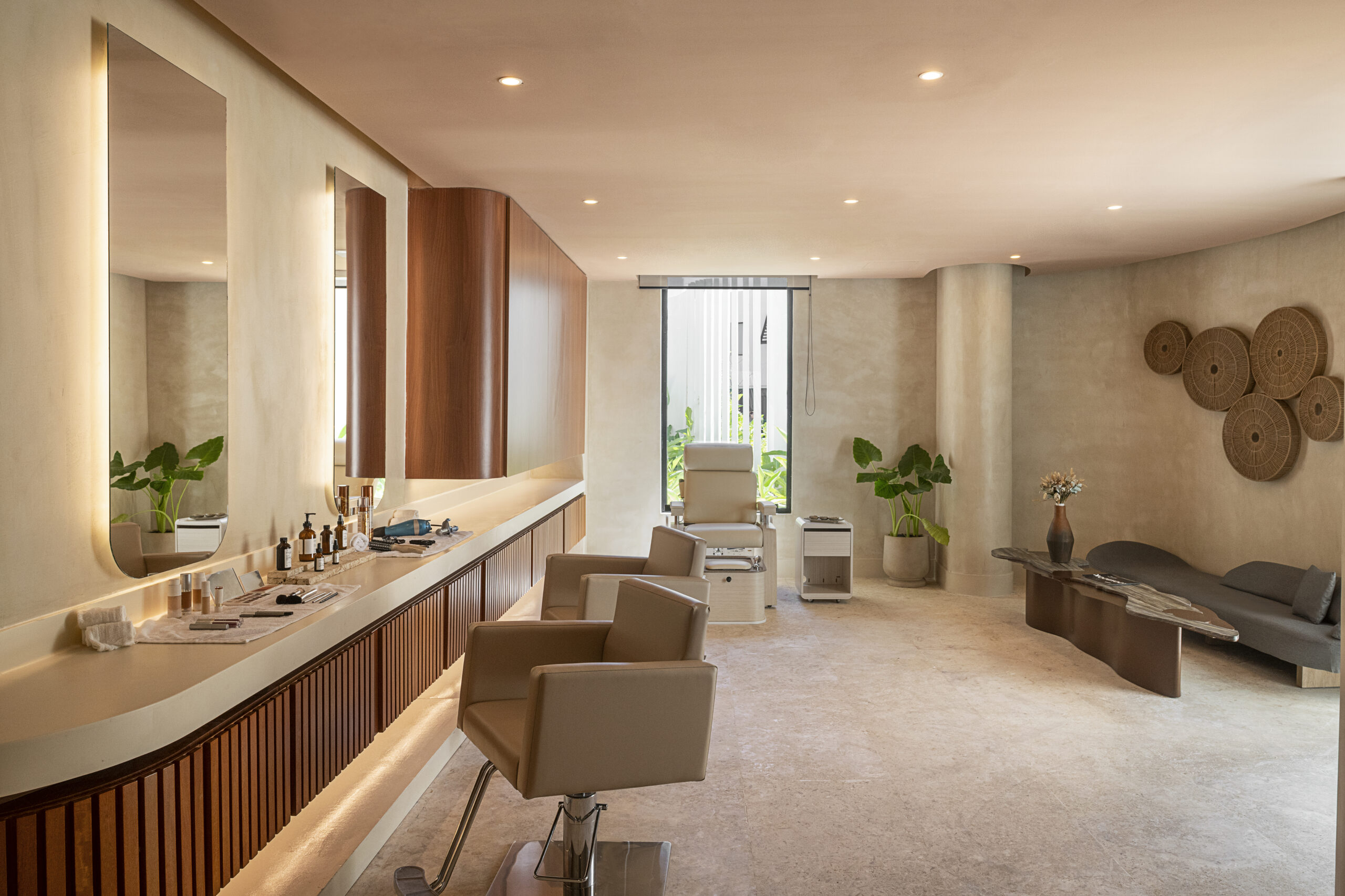 Zemi Miches spa treatment room with massage chairs and skincare products.