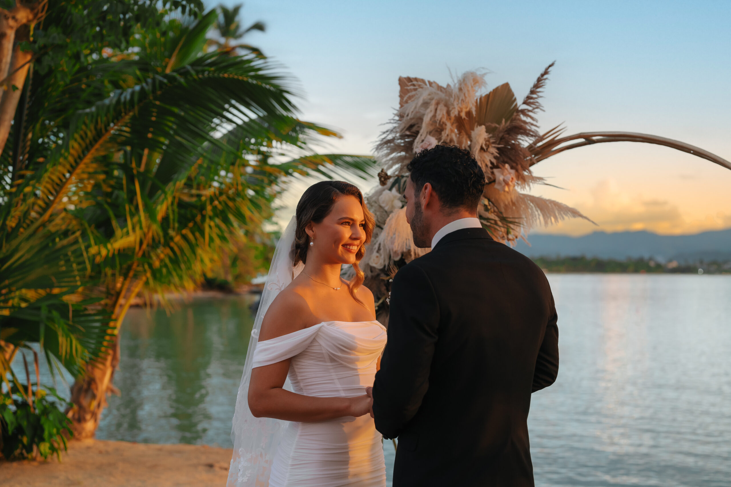 Wedding ceremony at Zemi Miches All-Inclusive Resort with bride and groom by the water