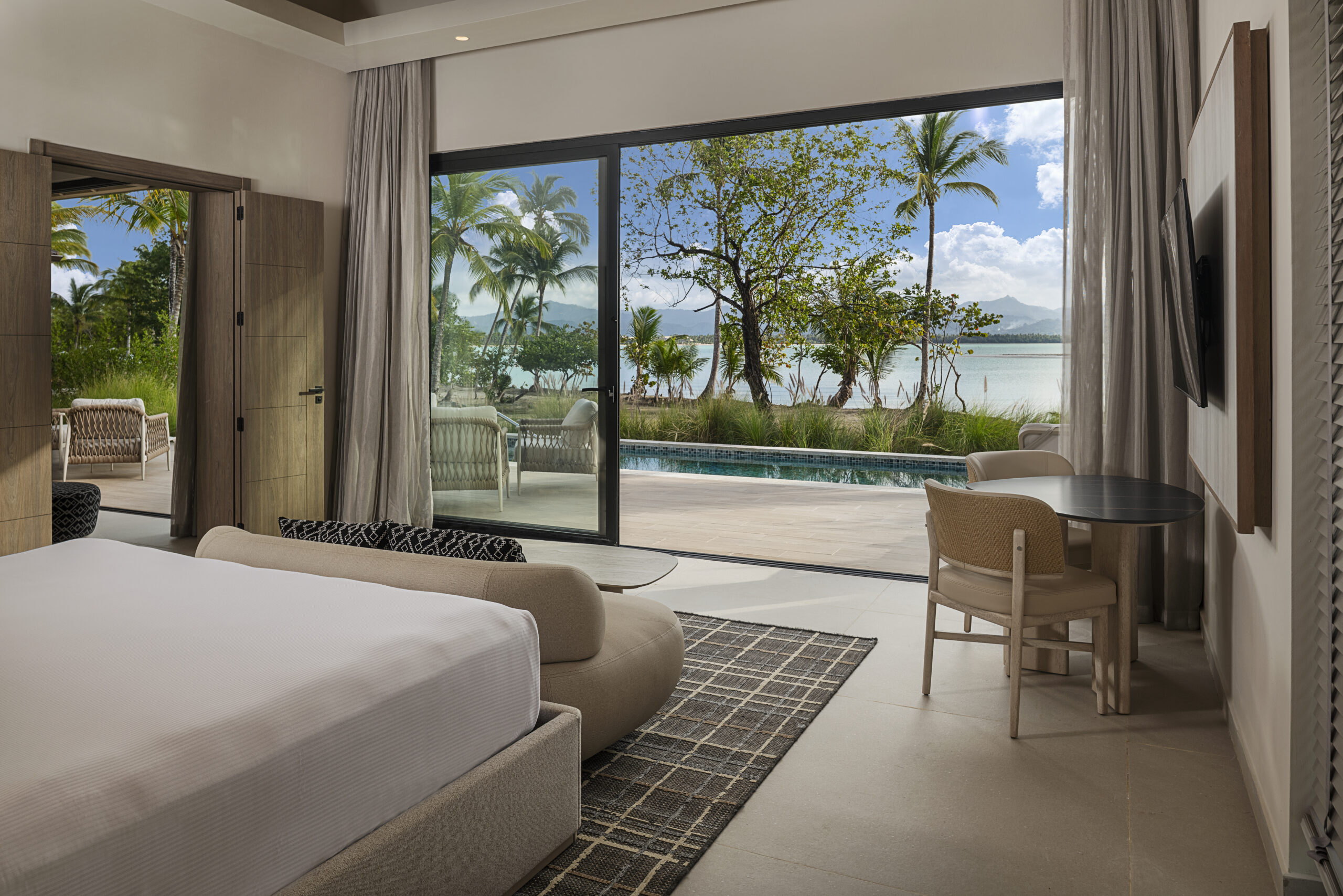 Zemi Miches resort suite with ocean view, pool, and king bed