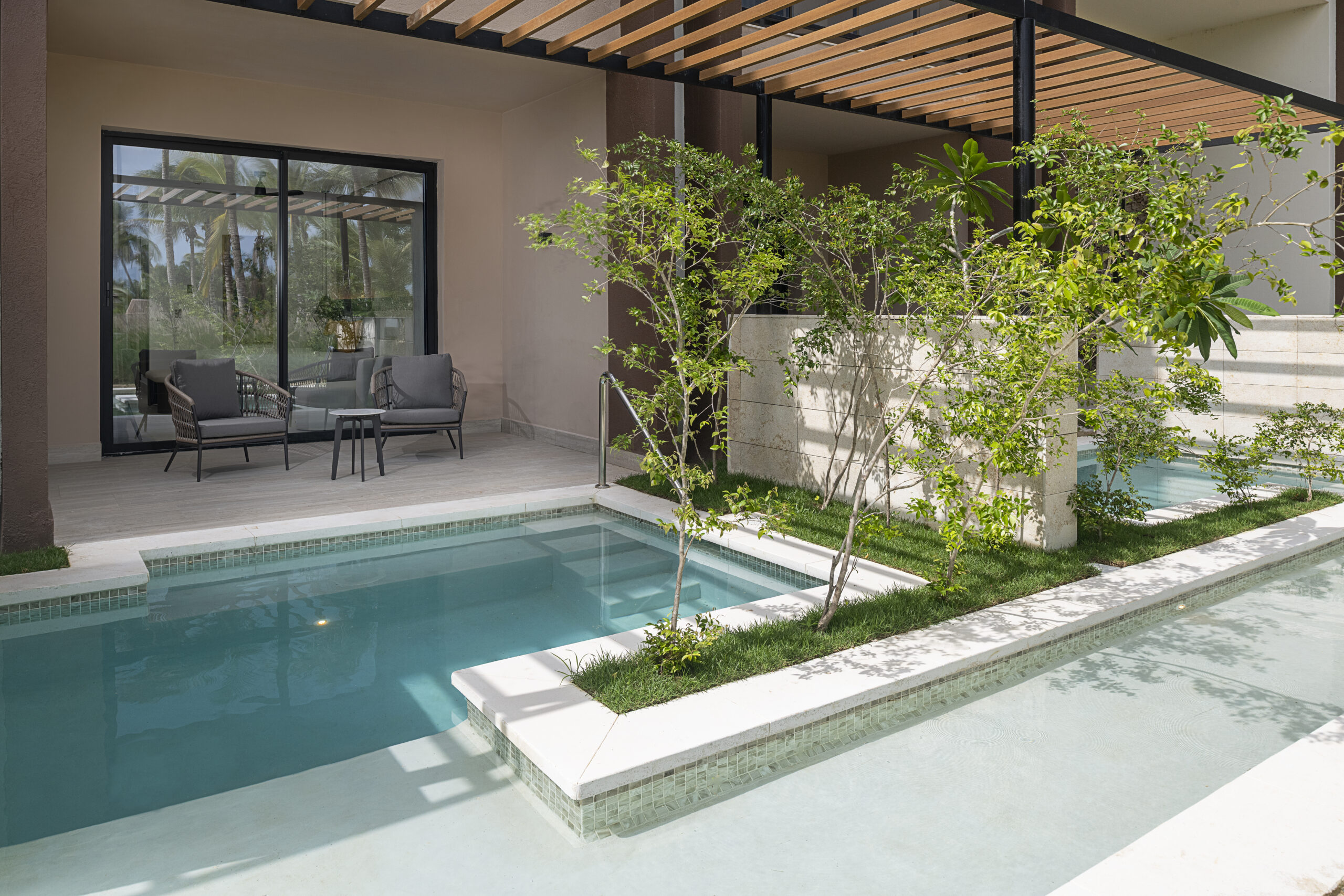 Outdoor pool area with lush greenery at Zemi Miches All-Inclusive Resort