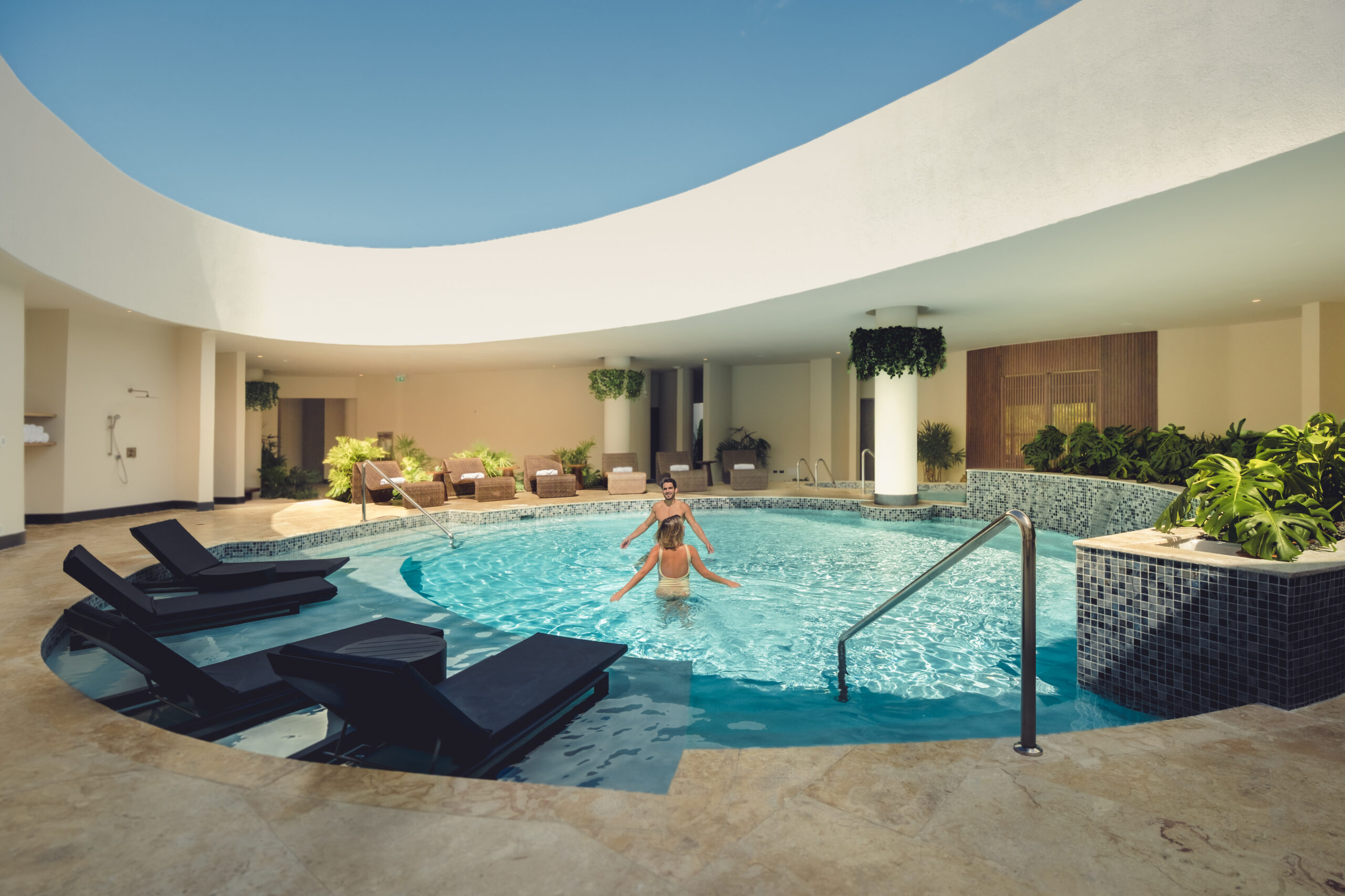 People enjoying the pool at Zemi Miches All-Inclusive Resort. Luxury resort swimming pool.