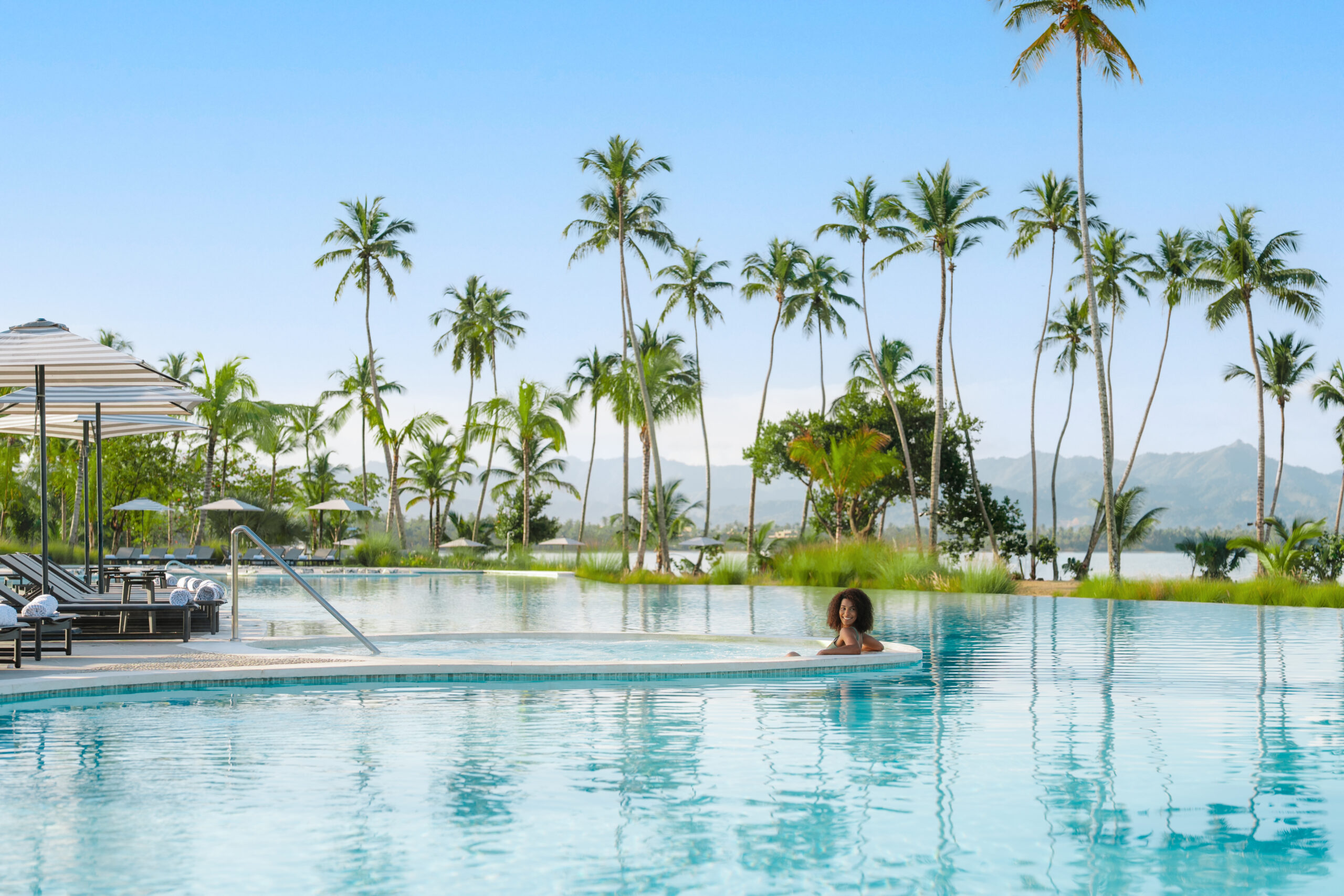 Woman relaxing in infinity pool at Zemi Miches All-Inclusive Resort