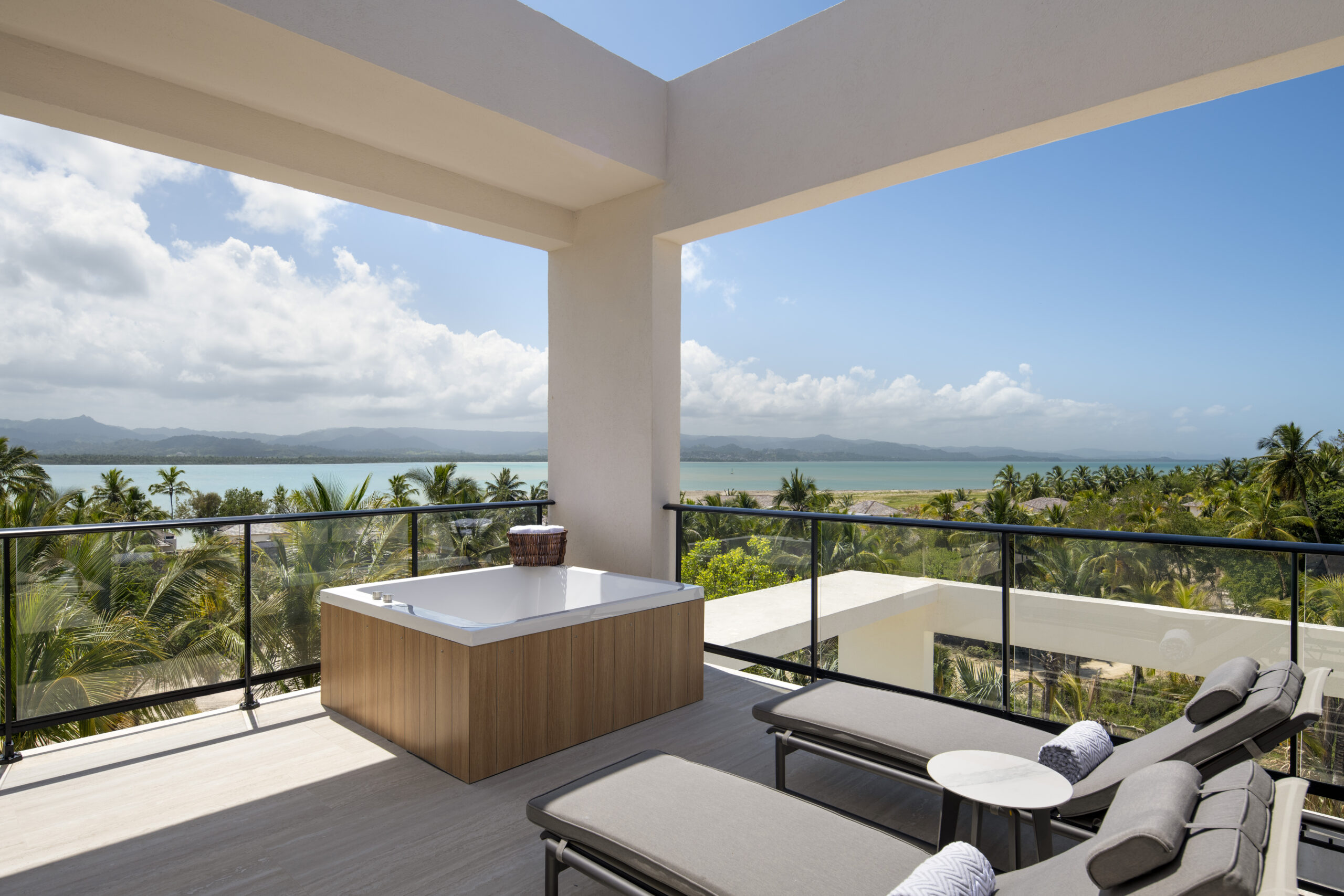 Zemi Miches All-Inclusive Resort balcony with hot tub and ocean view.