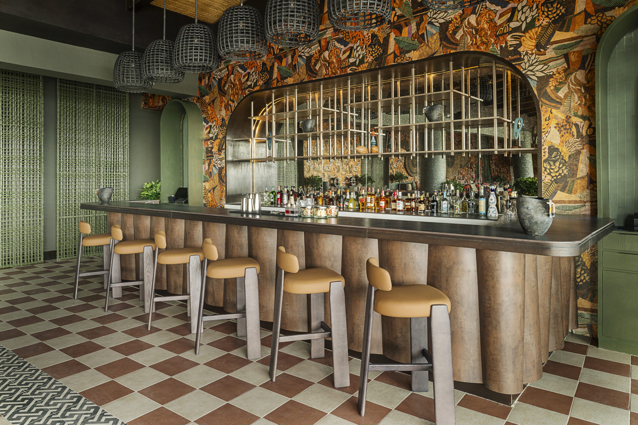 Bar at Zemi Miches All-Inclusive Resort with stylish stools and tropical decor.