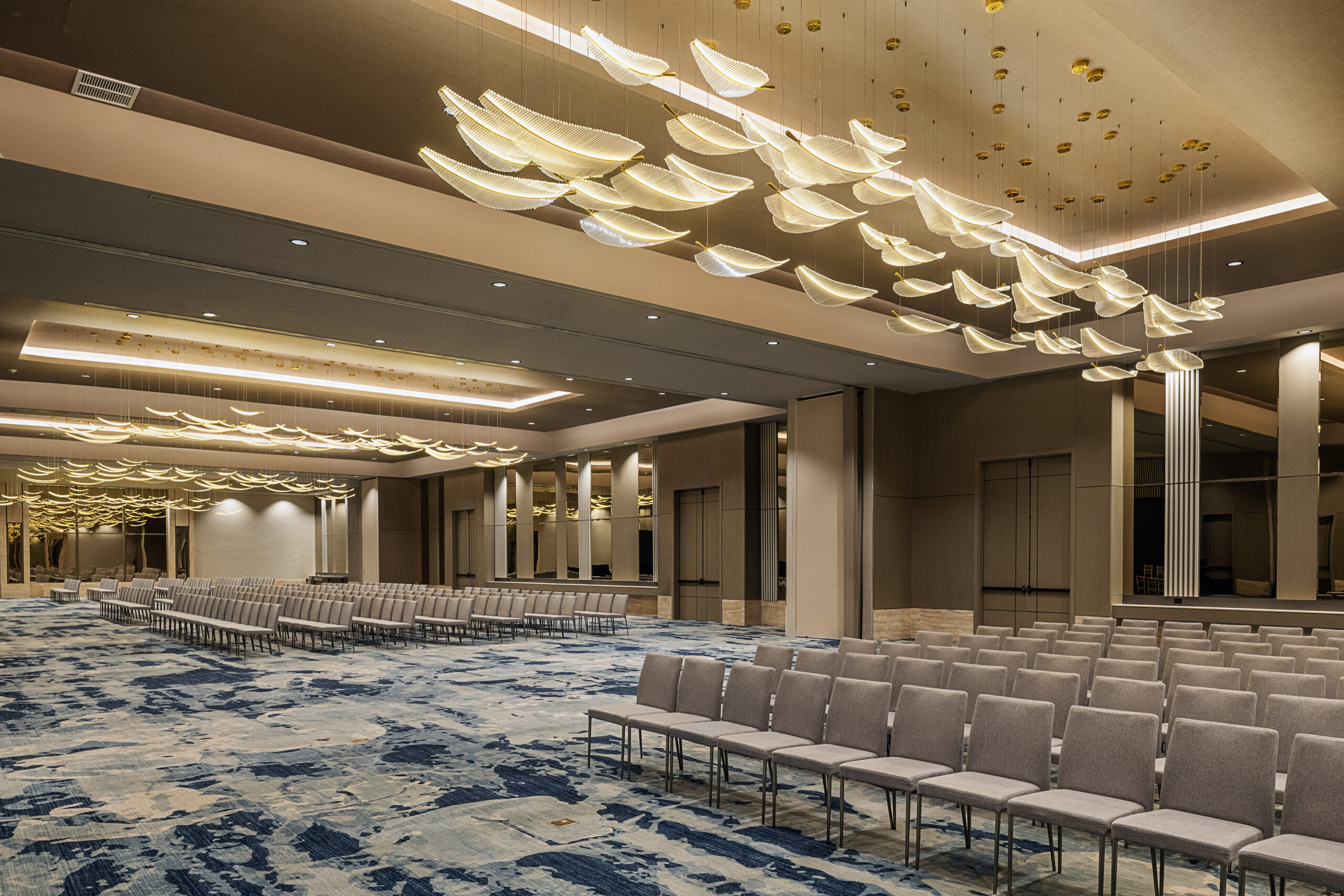 Zemi Miches All-Inclusive Resort ballroom with modern chandeliers and seating.