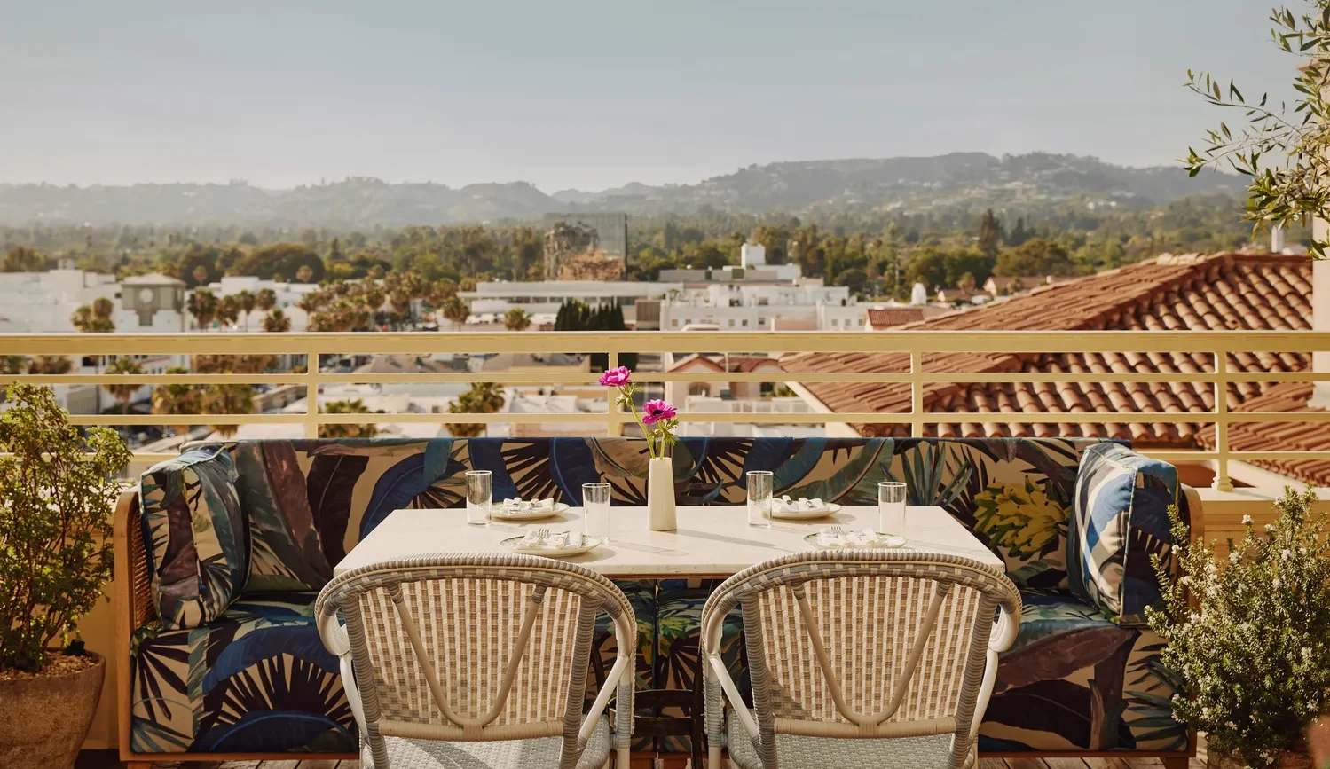 Romantic rooftop table setting at Maybourne Beverly Hills, overlooking city views. Ideal Beverly Hills wedding venue.
