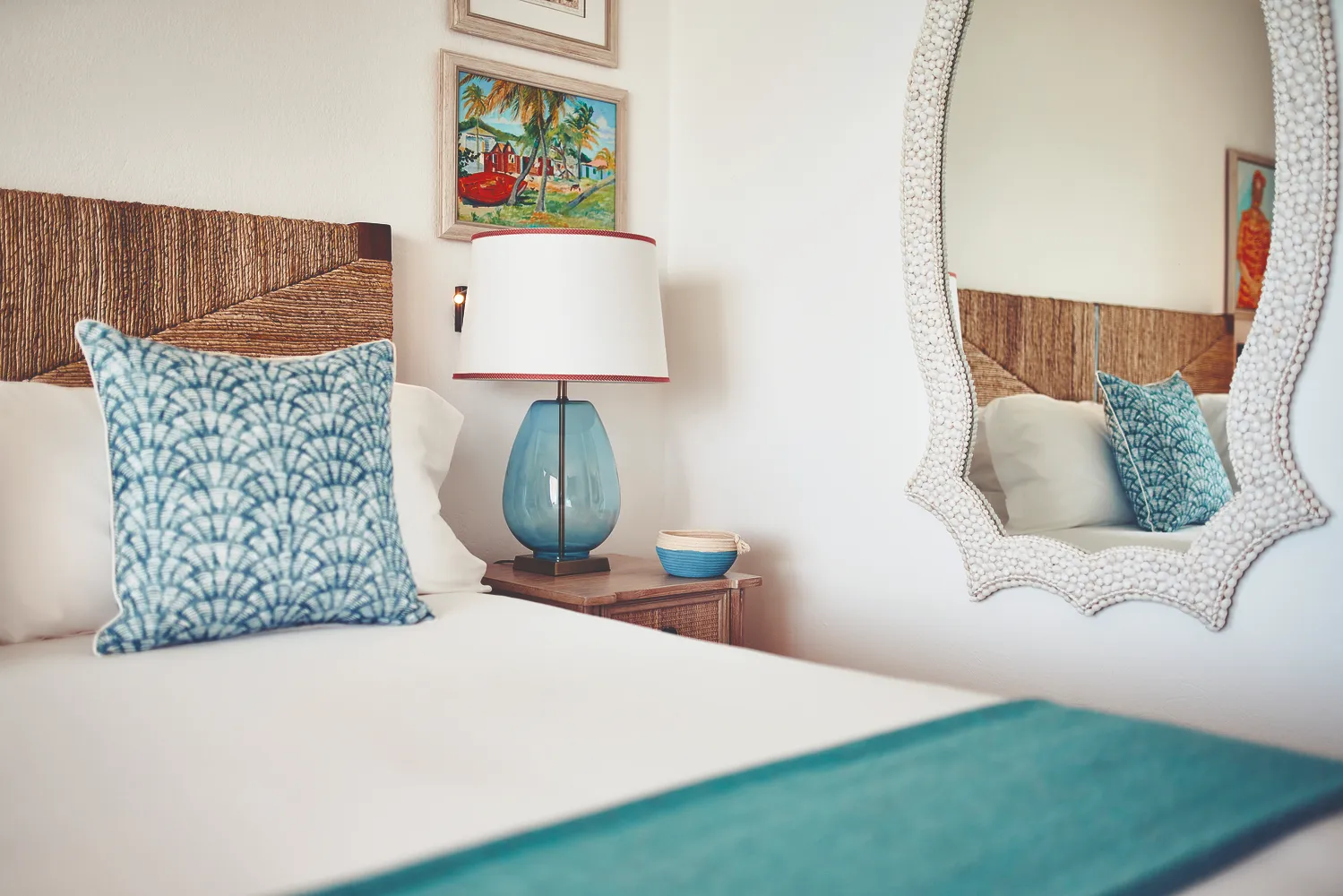Elegant Caribbean bedroom at La Samanna, a Belmond Hotel. Teal accents and tropical artwork.
