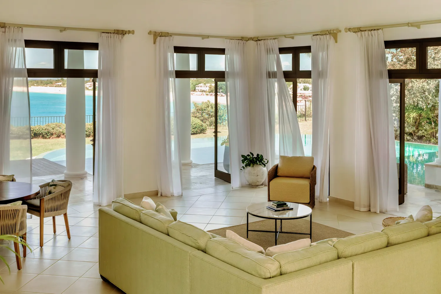 Luxurious living room overlooking Caribbean ocean; ideal La Samanna, Belmond Hotel wedding venue.