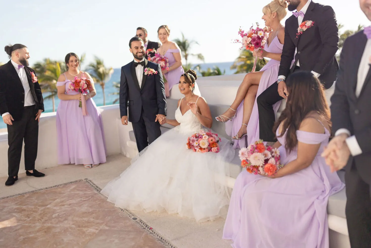 Happy bride and groom with bridesmaids and groomsmen at a Los Cabos wedding.