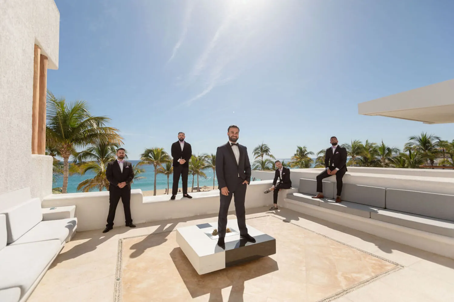 Groom and groomsmen in suits at a Los Cabos wedding destination.