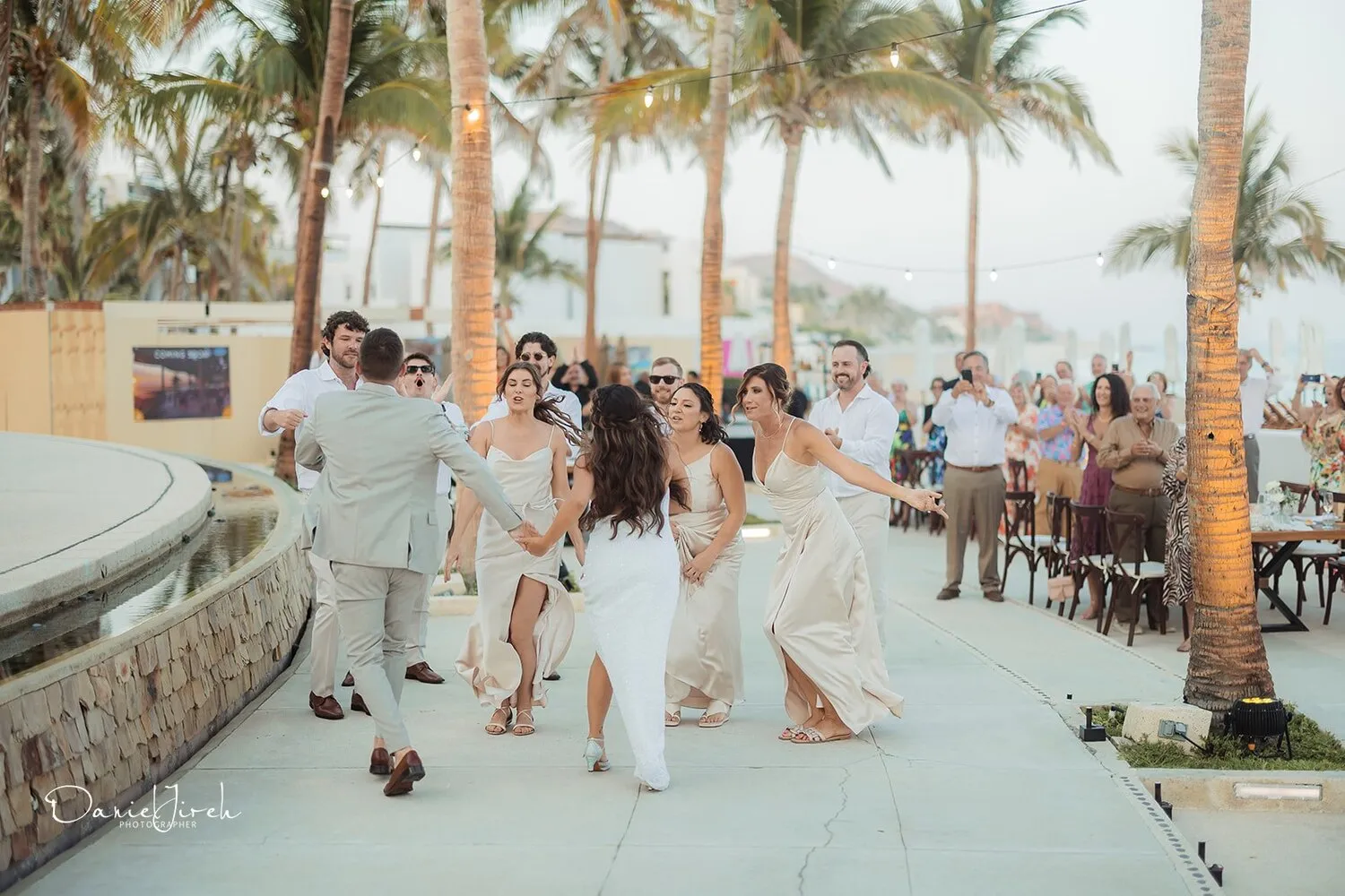 Bride and groom joyfully dancing with wedding party at Marquis Los Cabos, a stunning Los Cabos wedding destination.