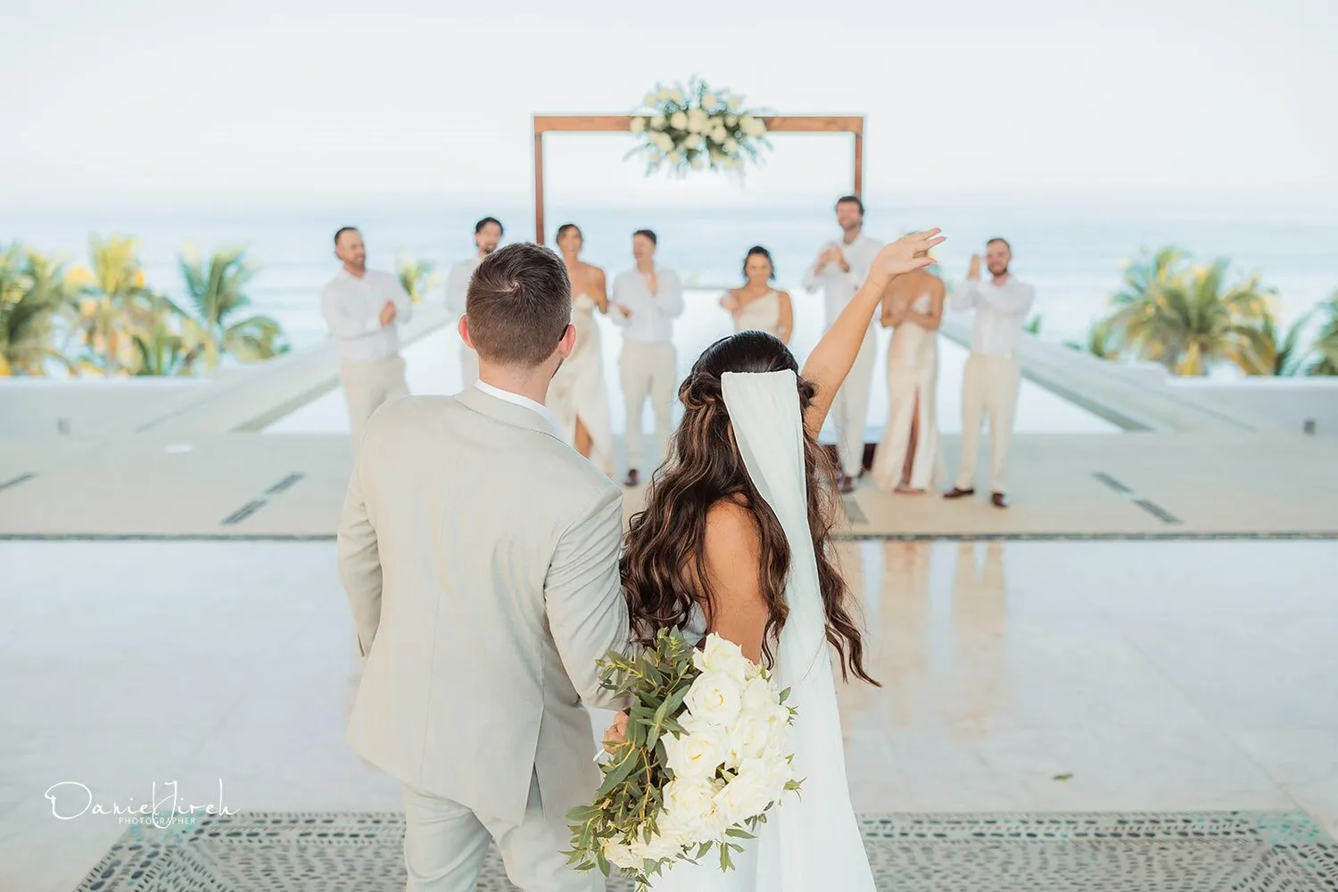 Bride and groom walking away from wedding ceremony at Marquis Los Cabos, Los Cabos wedding destination.