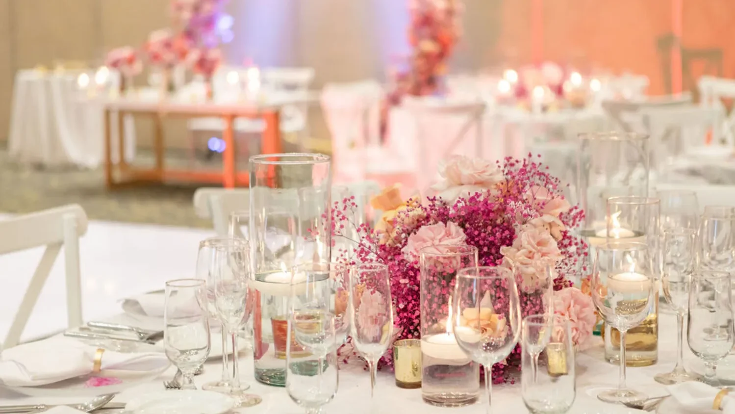 Elegant wedding centerpiece with pink flowers and candles at a Los Cabos wedding destination.