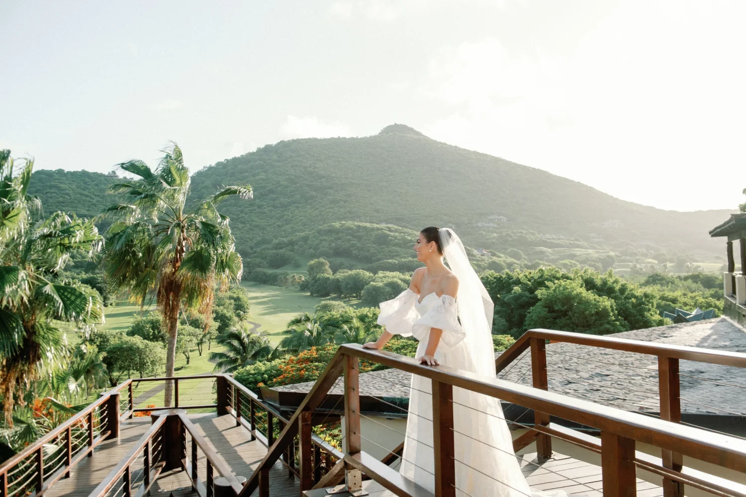 Bride in wedding dress on private island balcony overlooking ocean view. Private island wedding.