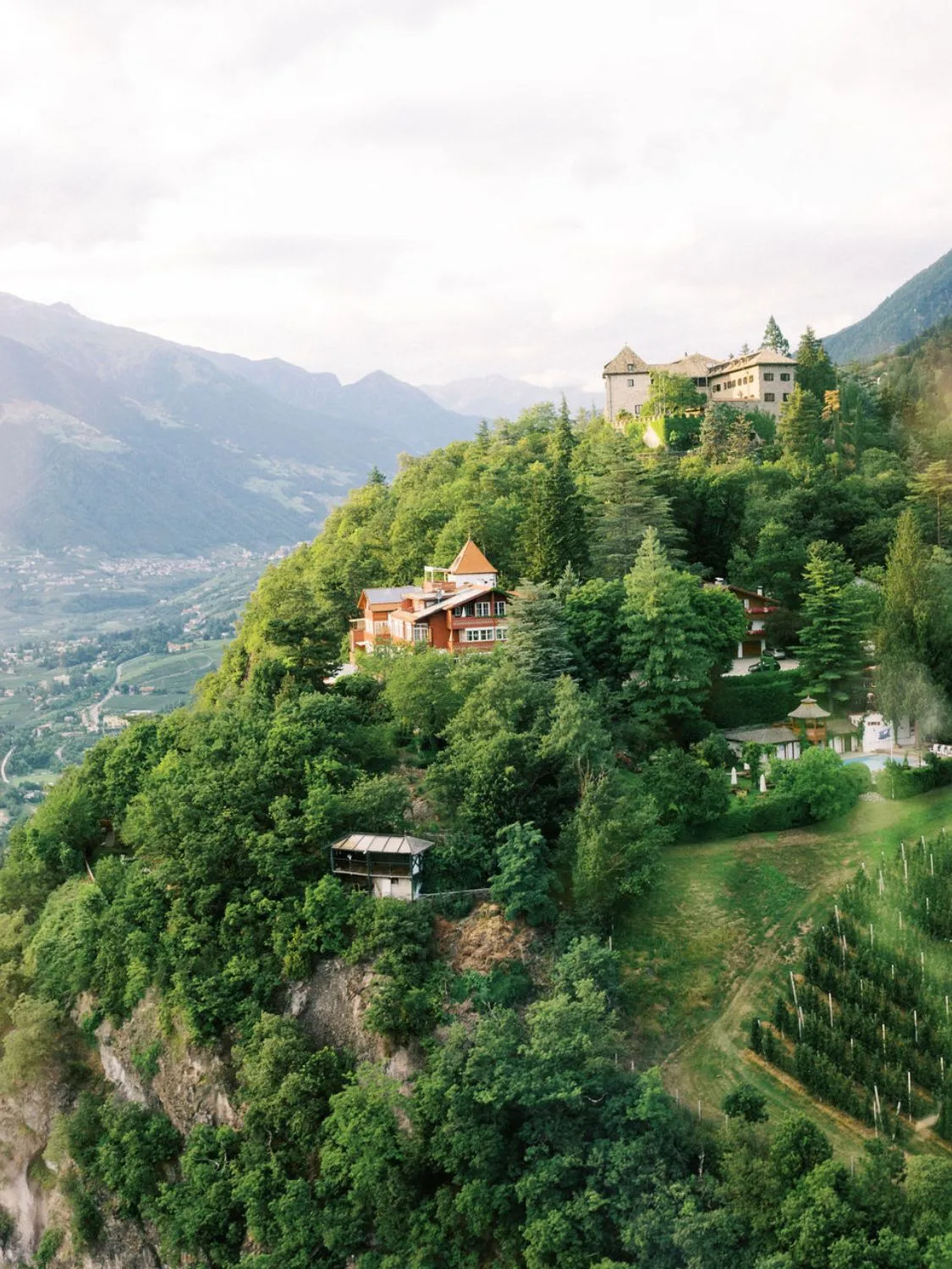 Mountaintop homes and castle overlook valley. A strong partnership between nature and architecture.