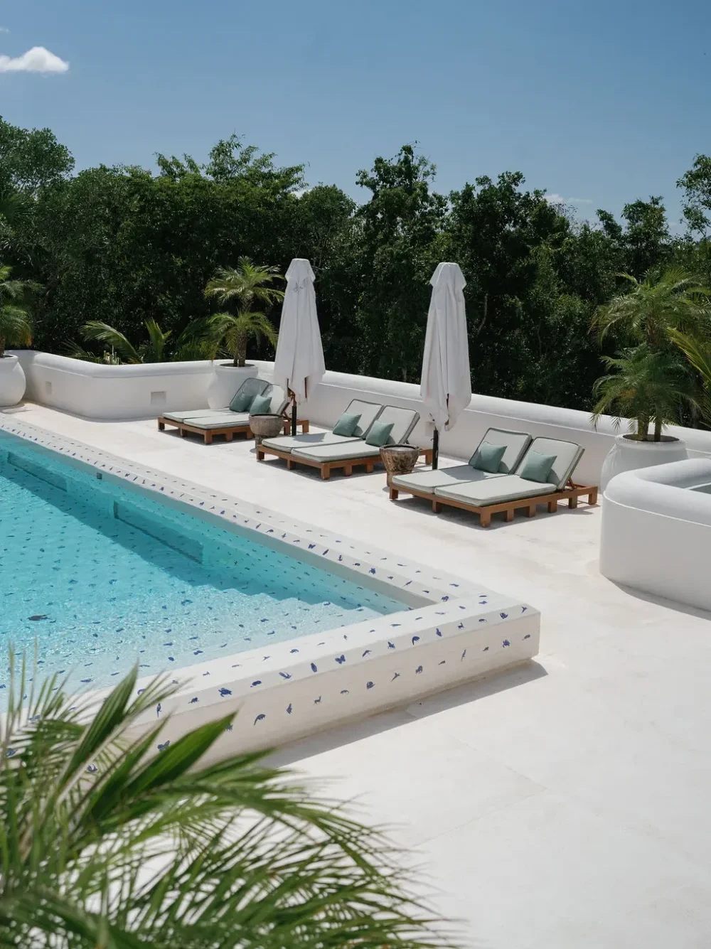 Luxury resort pool with lounge chairs and umbrellas. Relaxing vacation getaway.