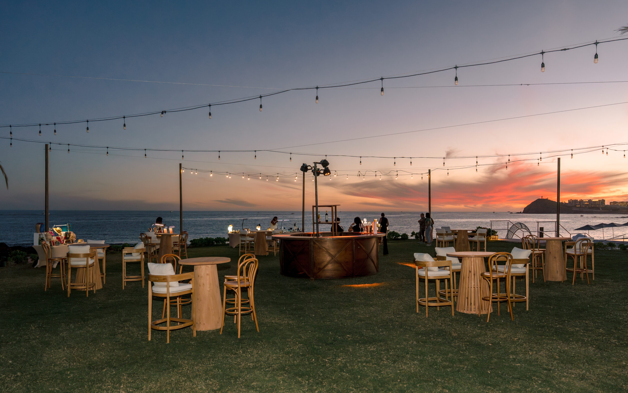 Park Hyatt Los Cabos wedding reception at sunset with string lights and ocean view.